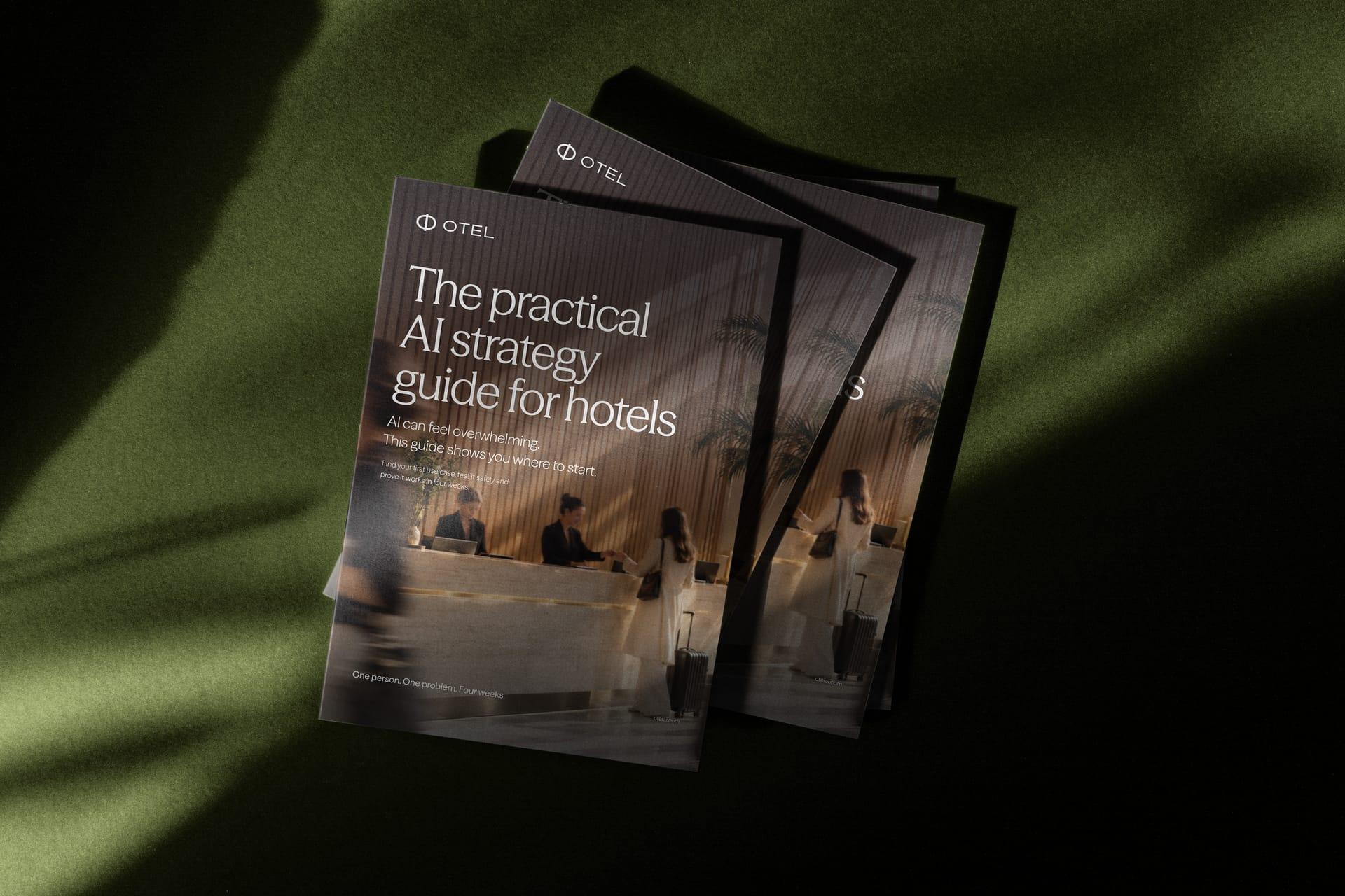 Printed copies of The Practical AI Strategy Guide for Hotels, fanned out on a green surface